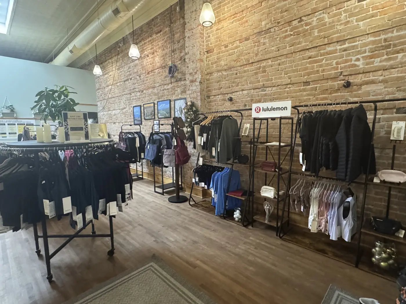 Apparel on racks along the boutique’s brick wall