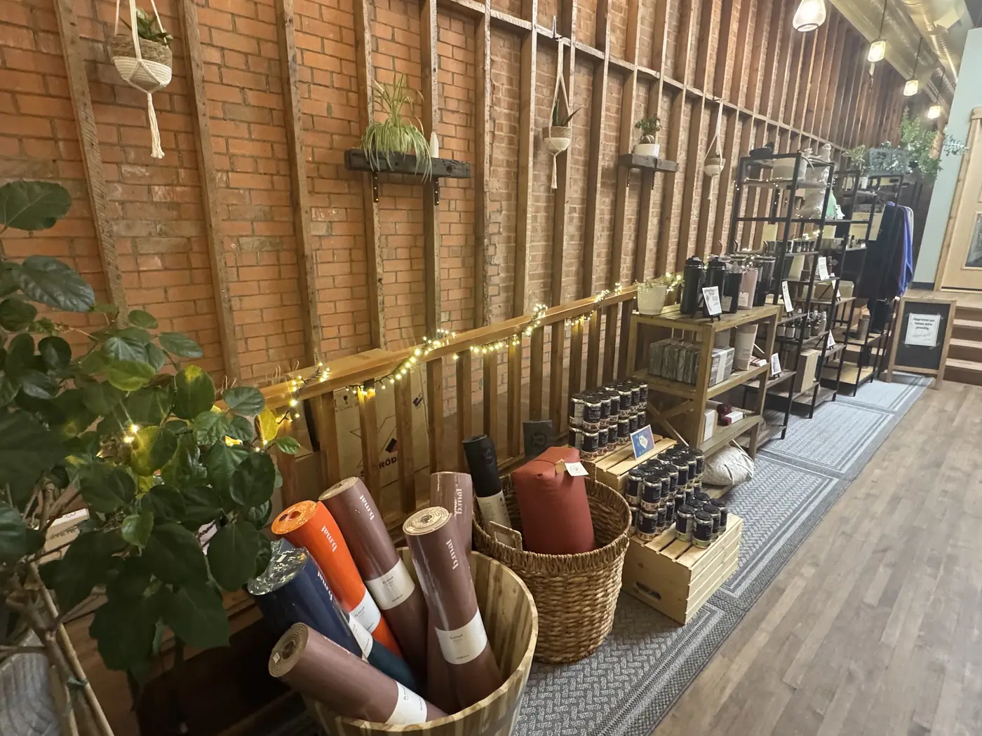 Rolled mats, bags and wellness products on the boutique’s timber shelves